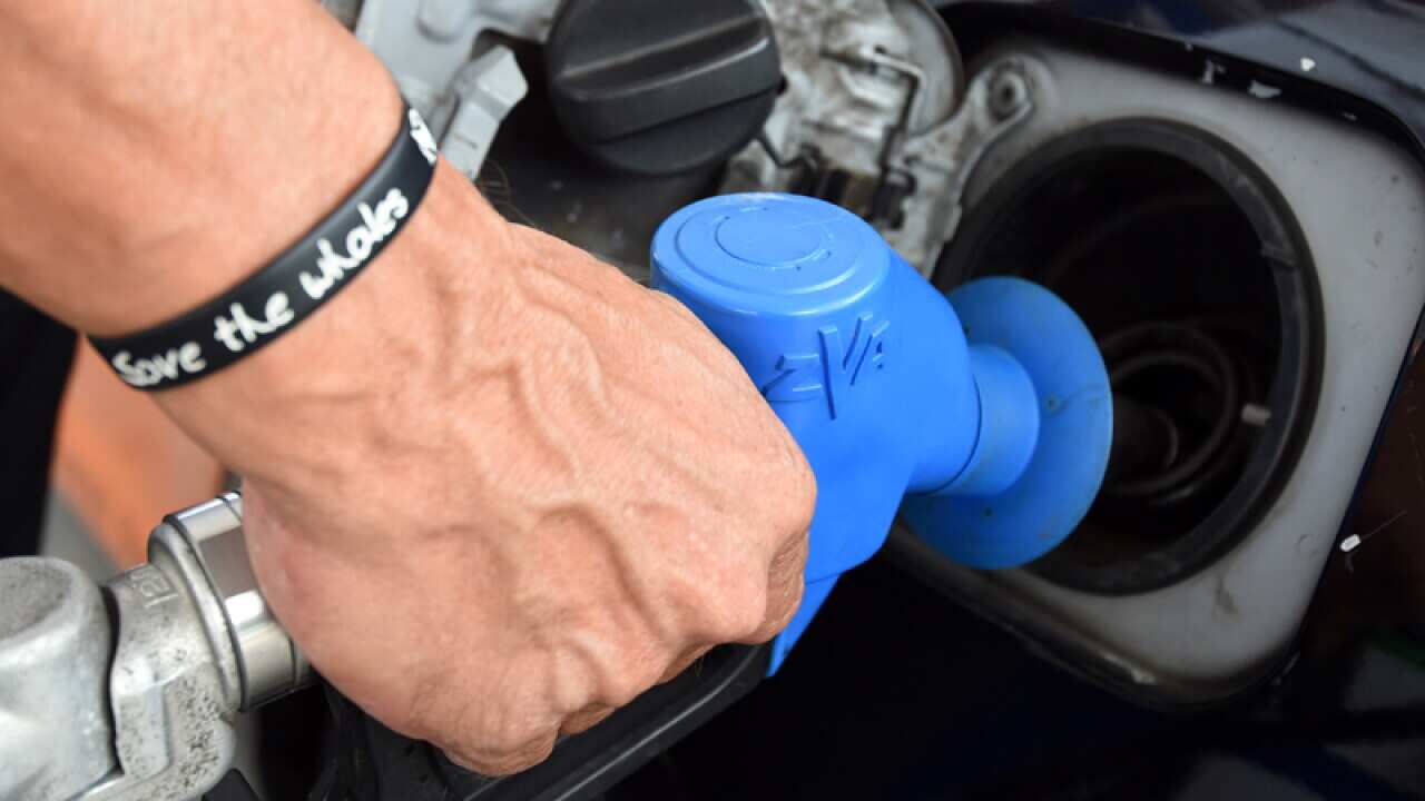 A motorist fills up their car at a petrol station