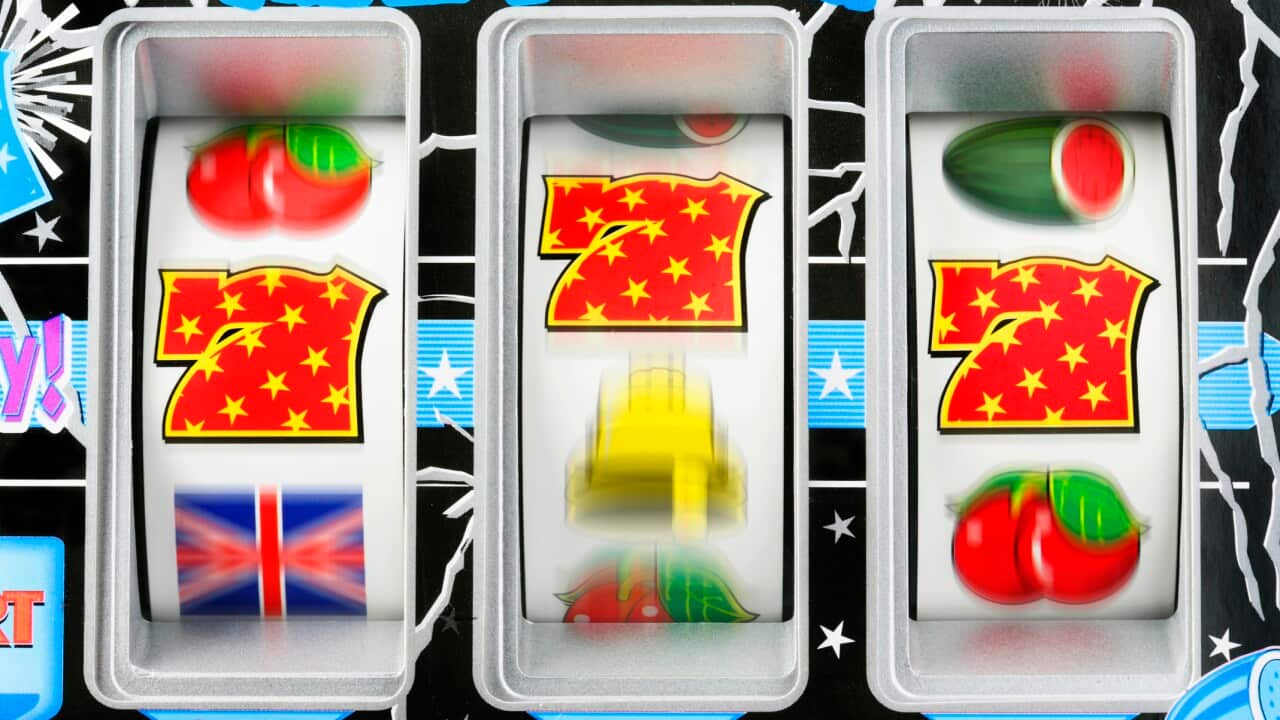 Fruit machine bars spinning to line of 7's, close-up (blurred motion)