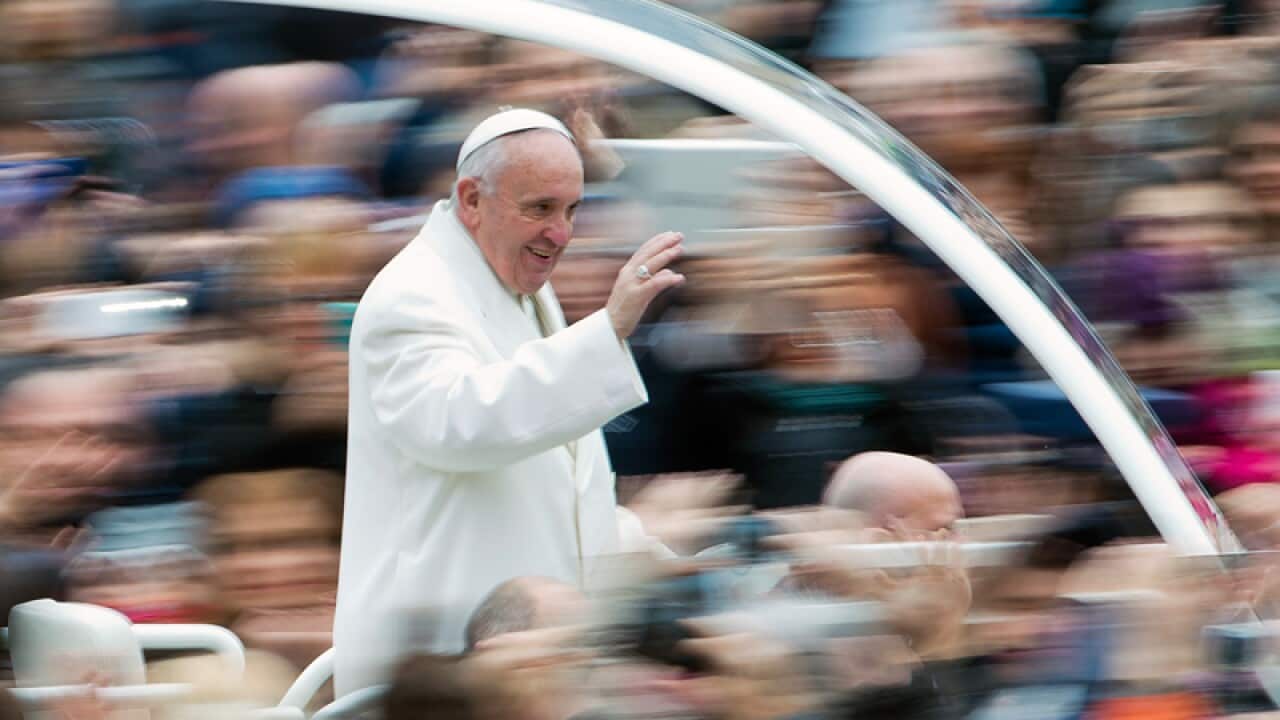 Pope Francis waves to faithful at the Vatican
