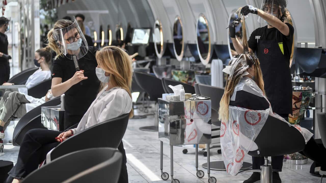 Clients get their hair done at a hairdresser in Milan, Italy, Monday, May 18, 2020 as Italy is slowly lifting sanitary restrictions after a two-month coronavirus lockdown. (Claudio Furlan/LaPresse via AP)