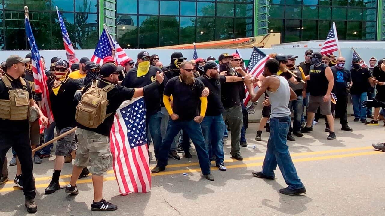 Members of the far-right group Proud Boys clash with counter-protesters in downtown Kalamazoo, Michigan.