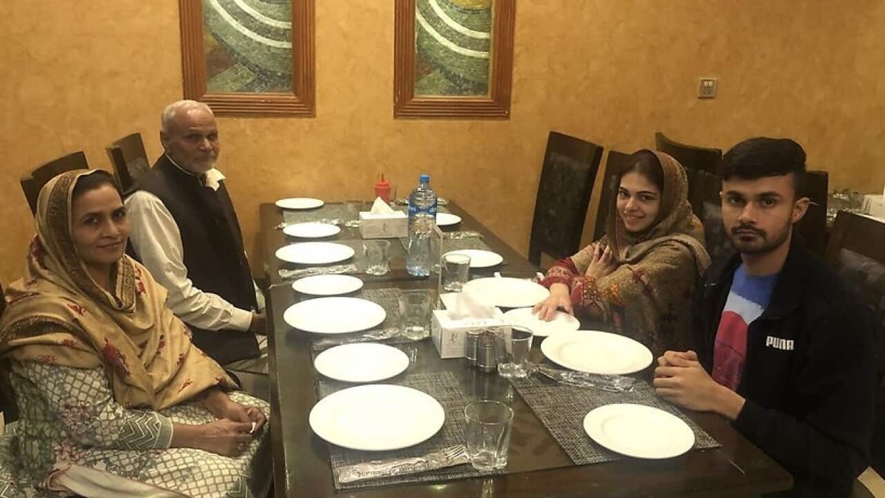 Haroon Iqbal with his mother and father.