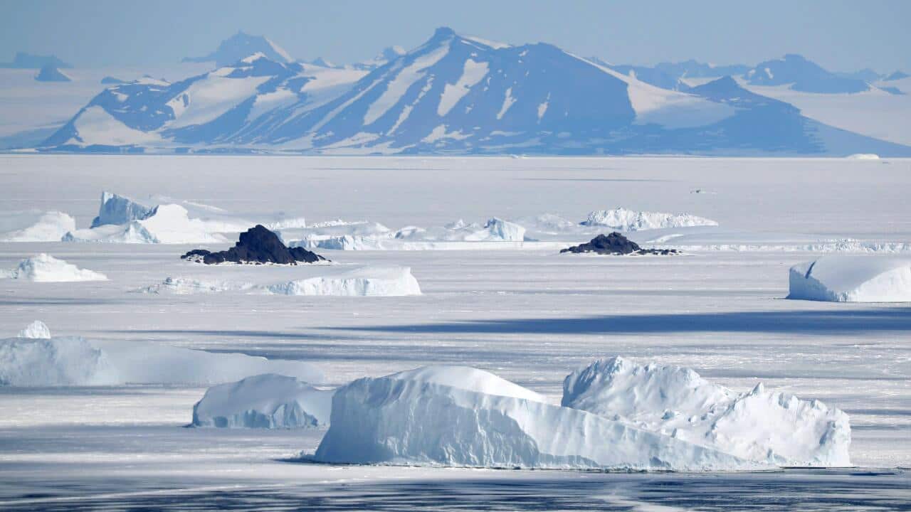 Mountains in Antarctica and ice floating in the Antarctic Sea.