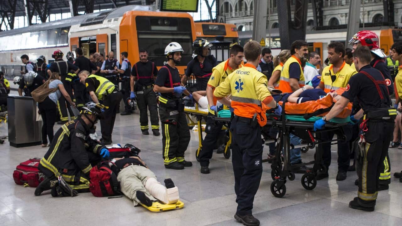 Spanish firefighters and paramedics treat injured people at Francia Railway Station in Barcelona.Spanish firefighters and paramedics treat injured people at Francia Railway Station in Barcelona.