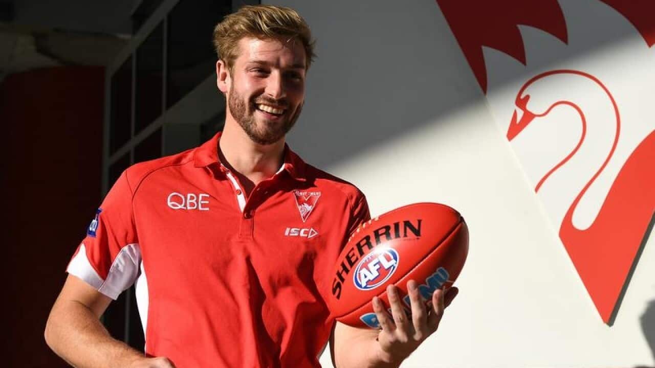 Sydney Swans AFL player Alex Johnson poses for the media.