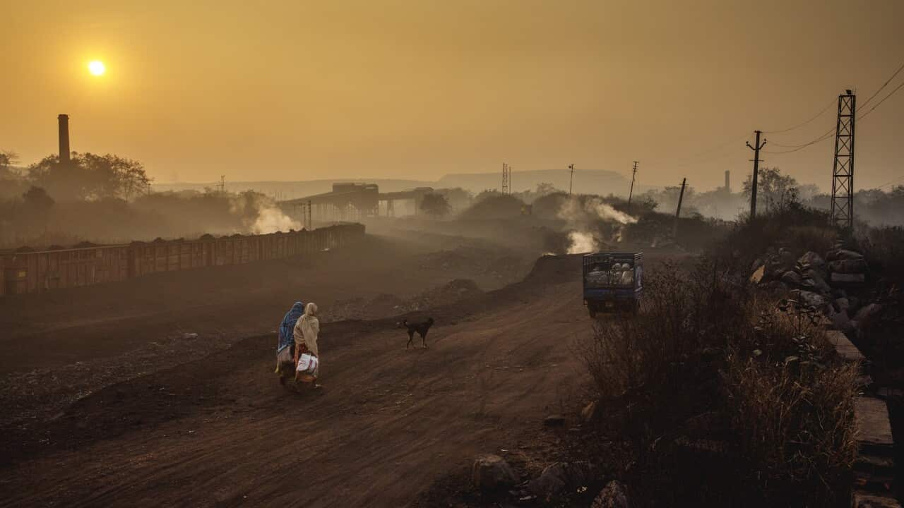 Early morning workers head to an Indian coal mine