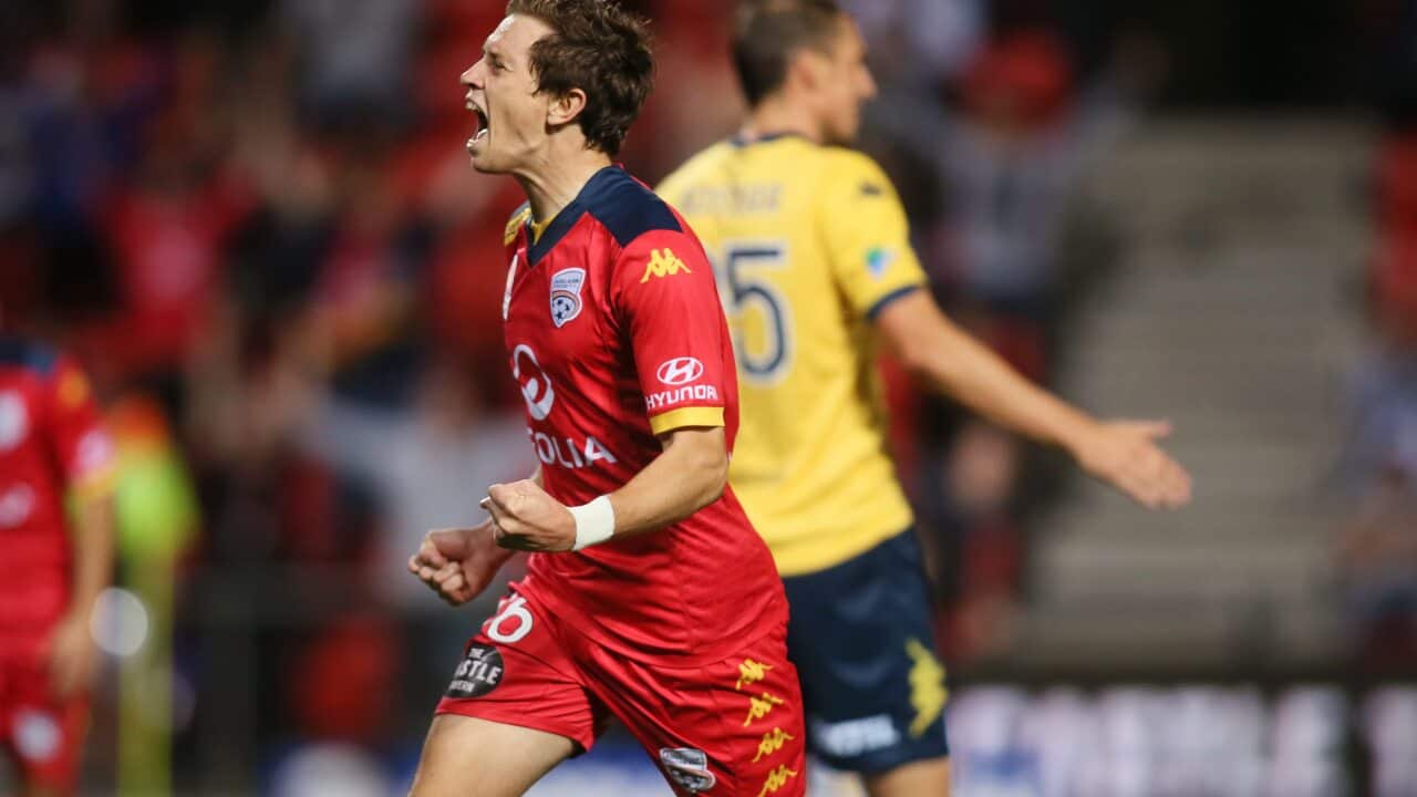 Craig Goodwin shows his delight at firing Adelaide's winner against Central Coast (AAP)