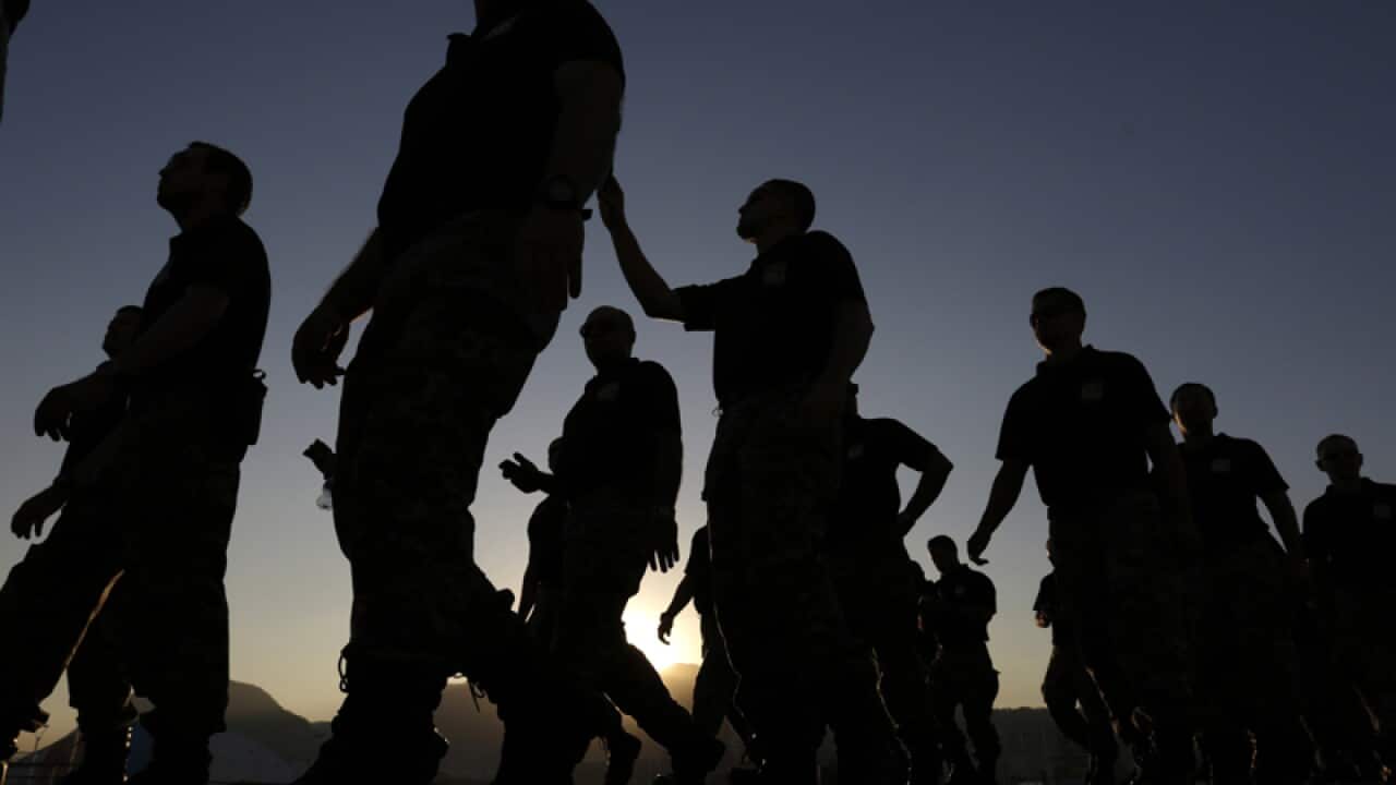 Officers leave after a security hand-over ceremony in Rio de Janeiro