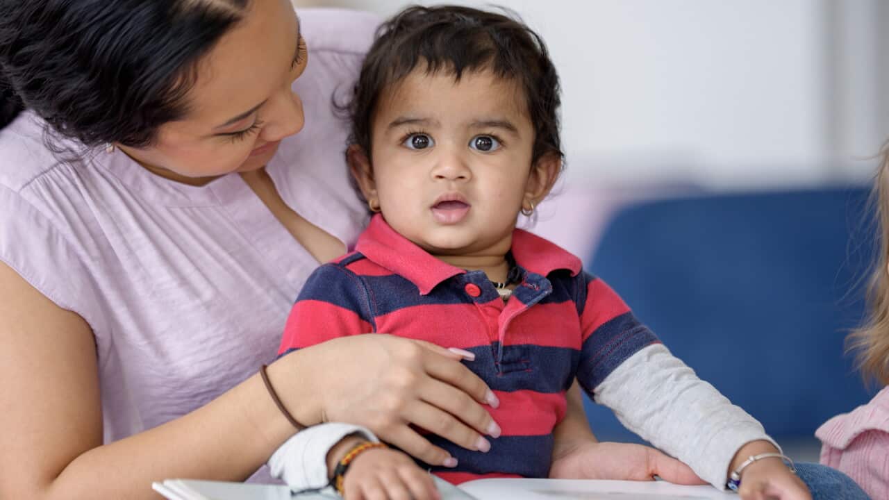 Hispanic Mother Reads With Her Toddler Child At Home, Warm Family Moment Of Bonding And Learning