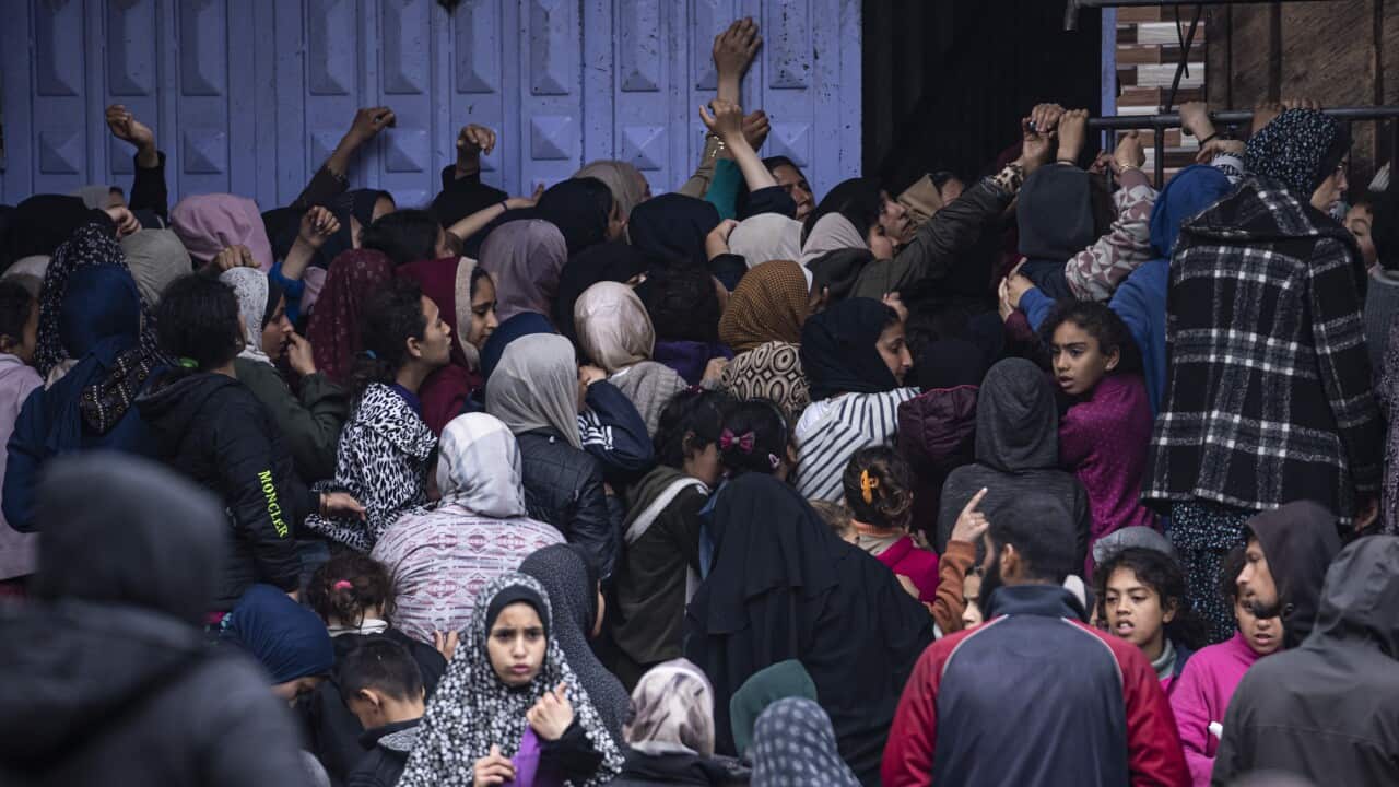 Crowds struggle to buy bread from a bakery in Rafah, Gaza Strip (AAP)