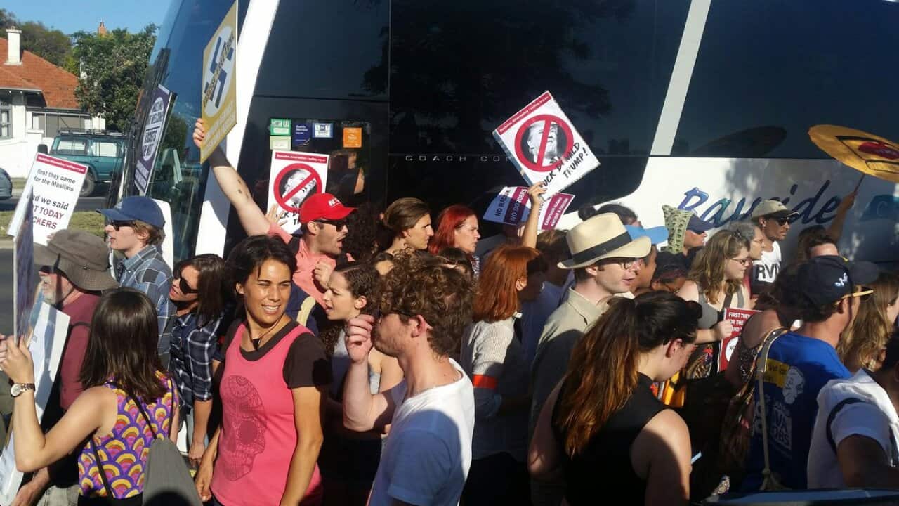 Protesters obstruct a bus taking people to an anti-Islam fundraising event.