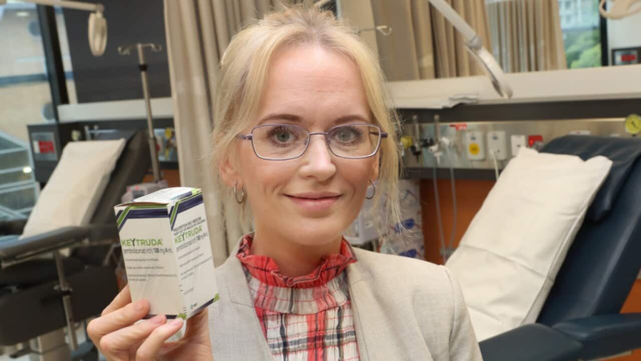 Patient Alison Beninati holds a box of Keyruda