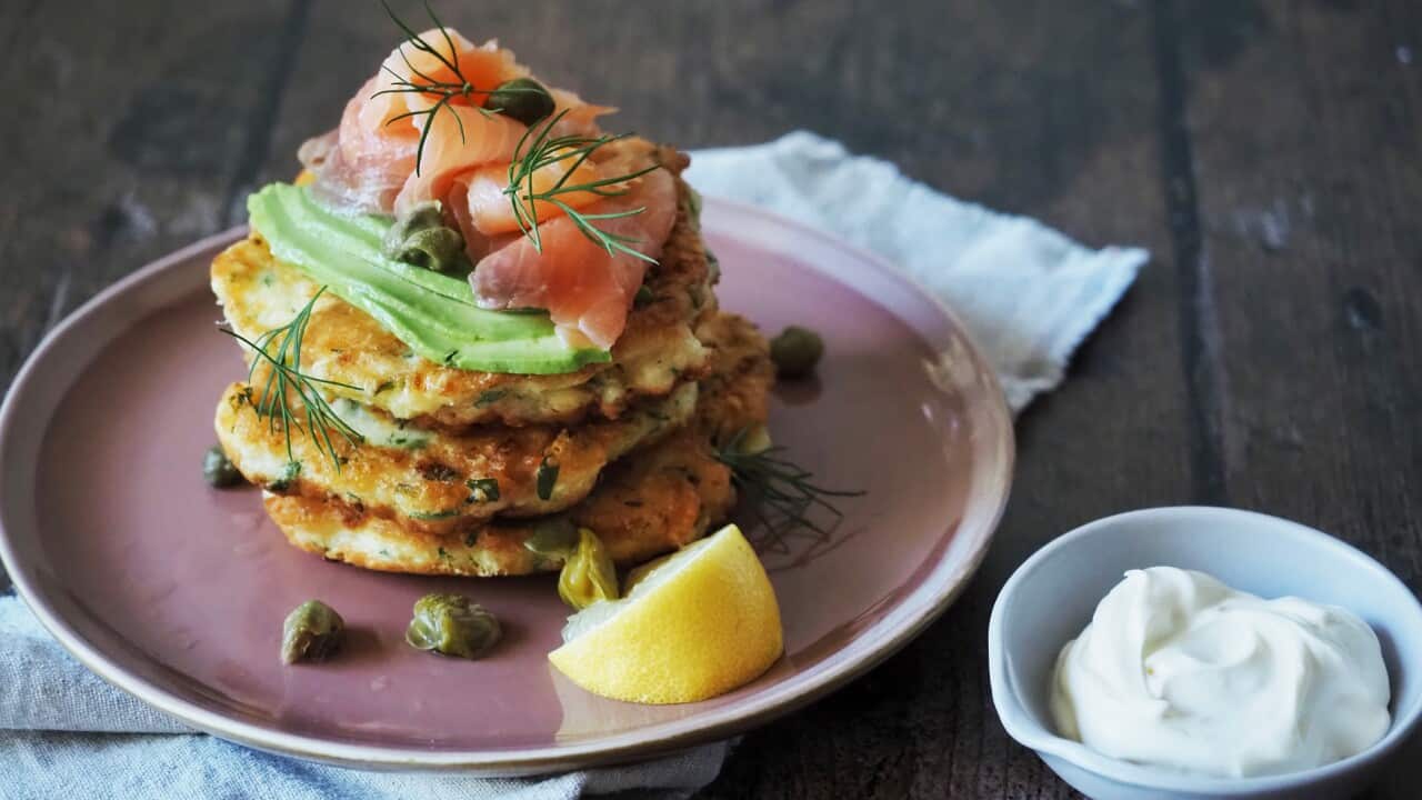 A stack of smoked salmon and ricotta fritters, served with creme fraiche on the side. 