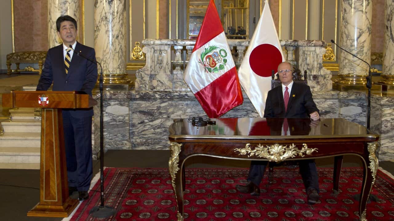 Japan's Prime Minister Shinzo Abe, left, gives a speech next to Peru's President Pedro Pablo Kuczynski after signing bilateral agreements.