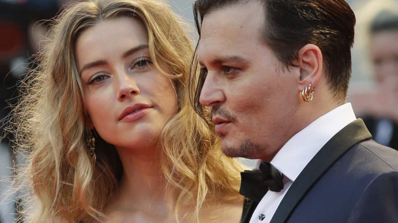 Amber Heard (L) and Johnny Depp