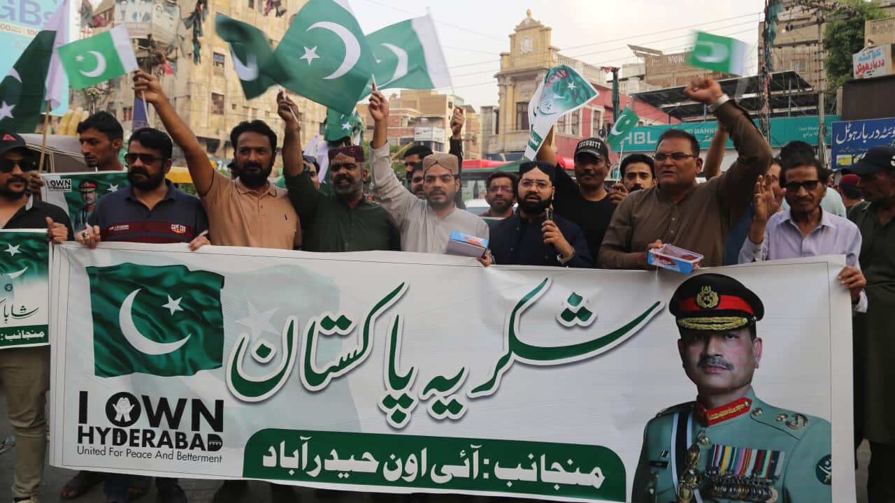 Traders hold a bannner praising Pakistani Field Marshal Syed Asim Munir and wave Pakistani flags during a rally in support of Iran and Pakistan's military leadership in Hyderabad, Pakistan, 08 April 2026.