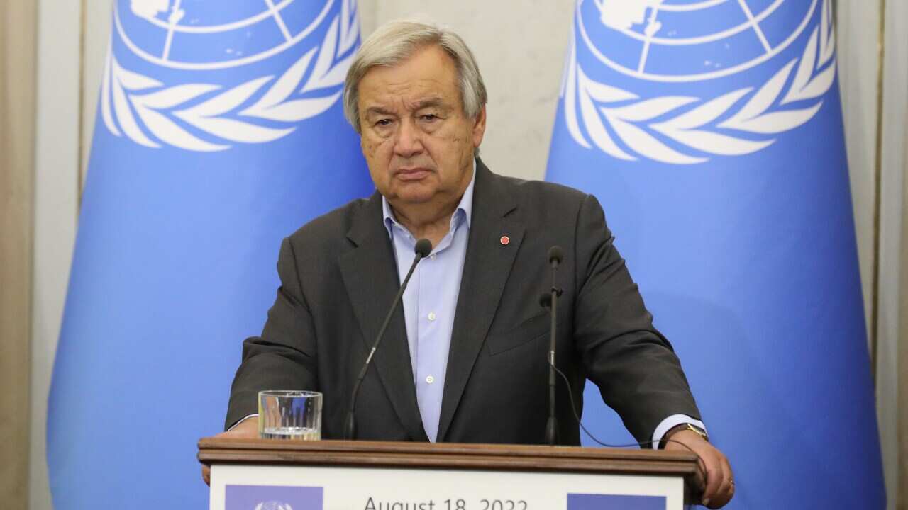UN Secretary-General Antonio Guterres standing at a lecturn