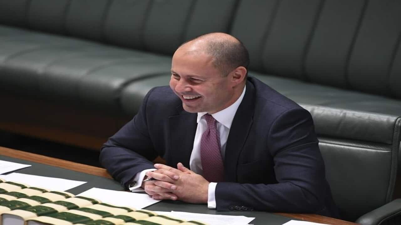 Josh Frydenberg laughs during a tax cuts debate in parliament.