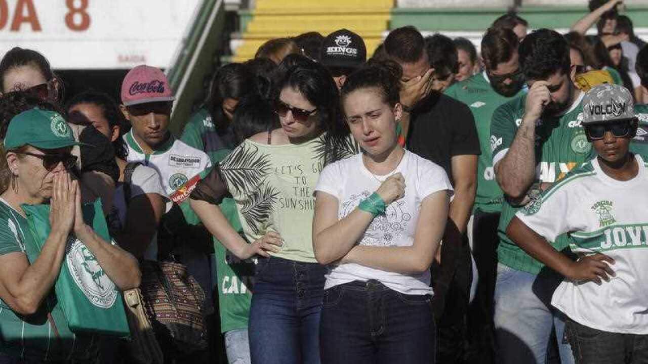 Supporters of Brazil's soccer team Chapecoense mourn the death of many of the team's players inside Arena Conda stadium in Chapeco, Brazil