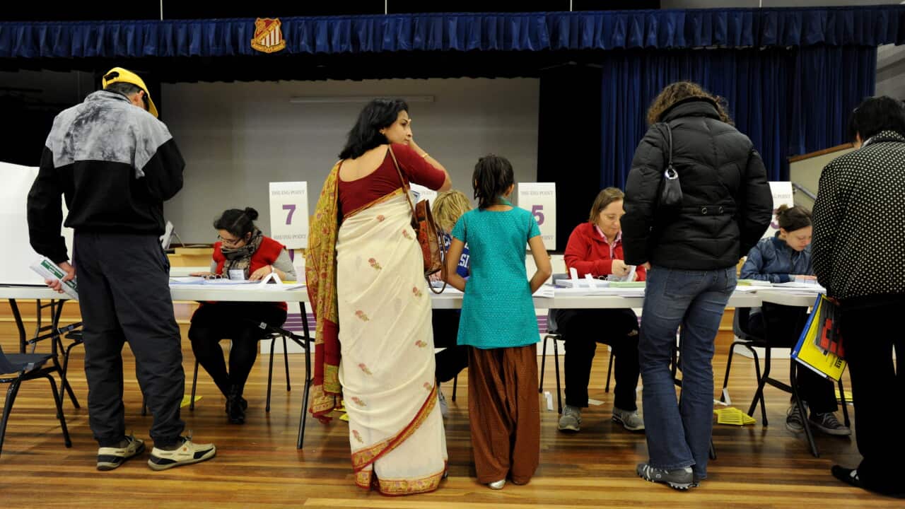 Voters queue at a polling booth