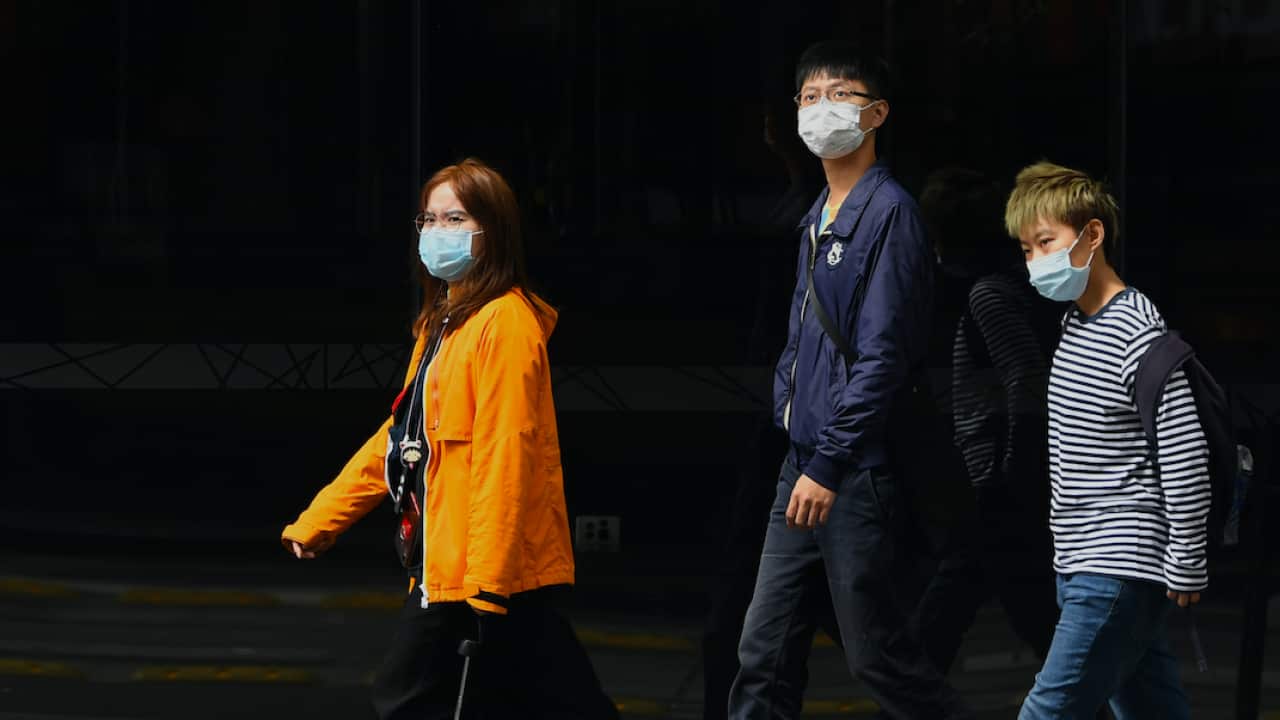 Pedestrians seen wearing a face masks in Sydney.