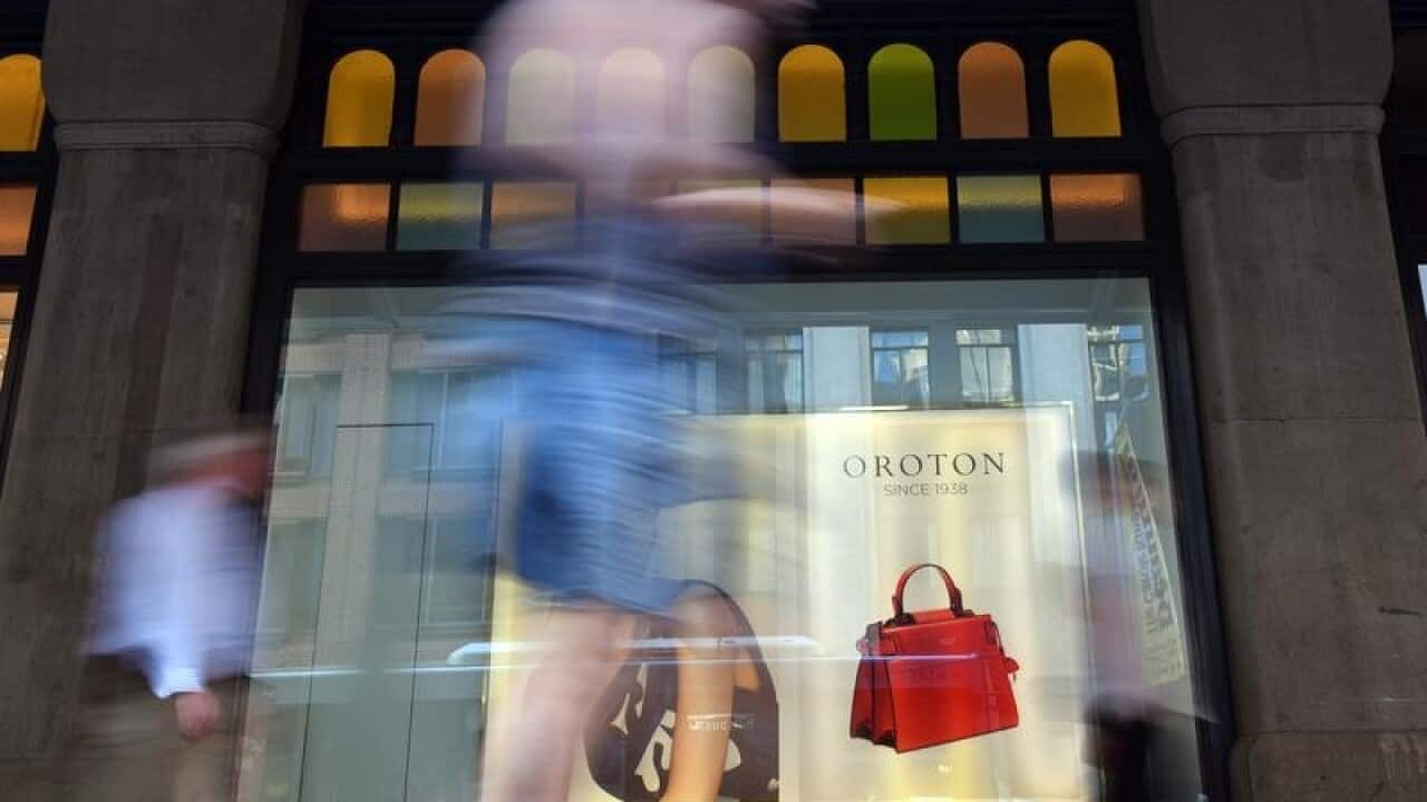A file image of pedestrians walking past an Oroton retail store