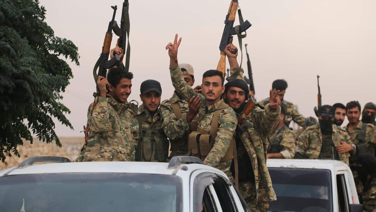 A convoy of Turkish backed Free Syria Army is about to cross into Turkey near the town of Azaz, Syria, Wednesday, Oct. 16, 2019. (AP Photo)