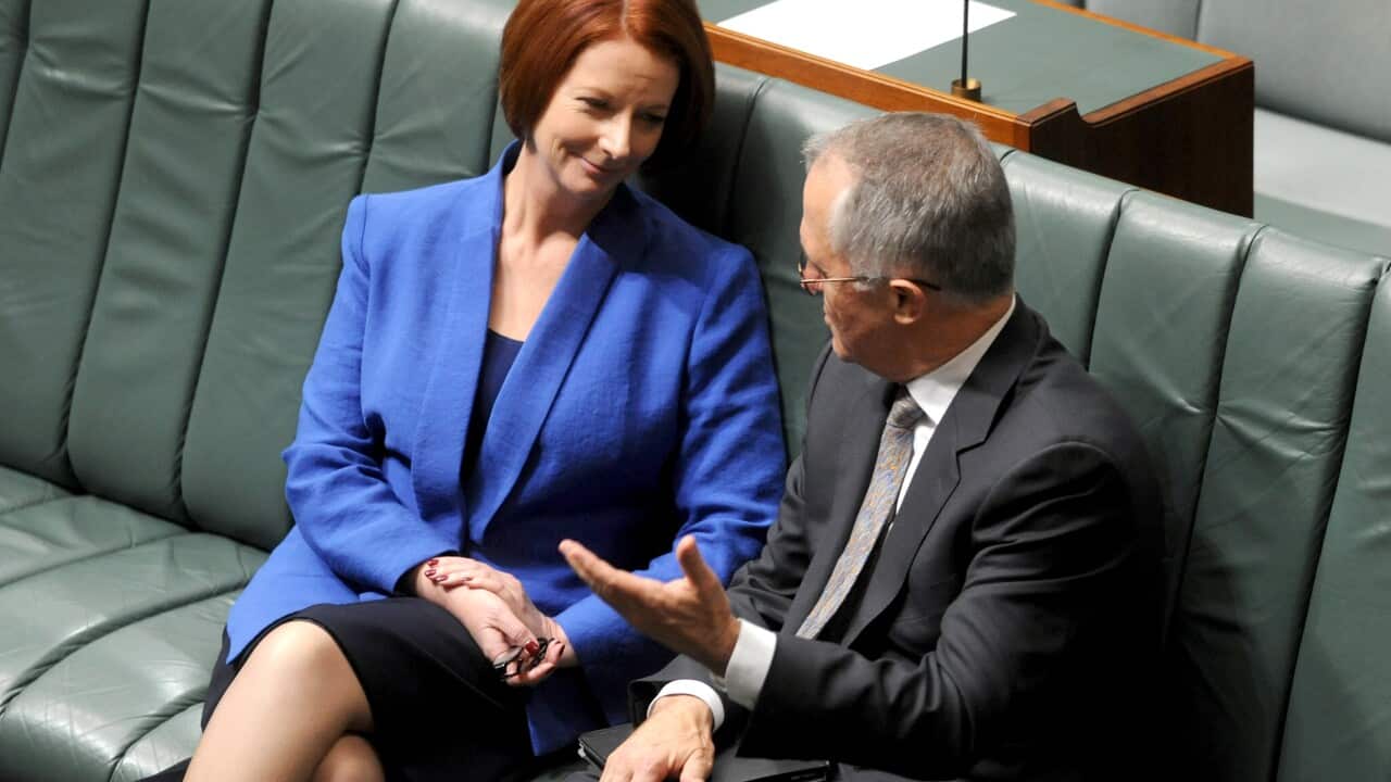 Prime Minister Julia Gillard sits for a chat with shadow communications minister Malcolm Turnbull after House of Representatives question time in Canberra, Wednesday, Sept.19, 2012. (AAP Image/Alan Porritt) NO ARCHIVING