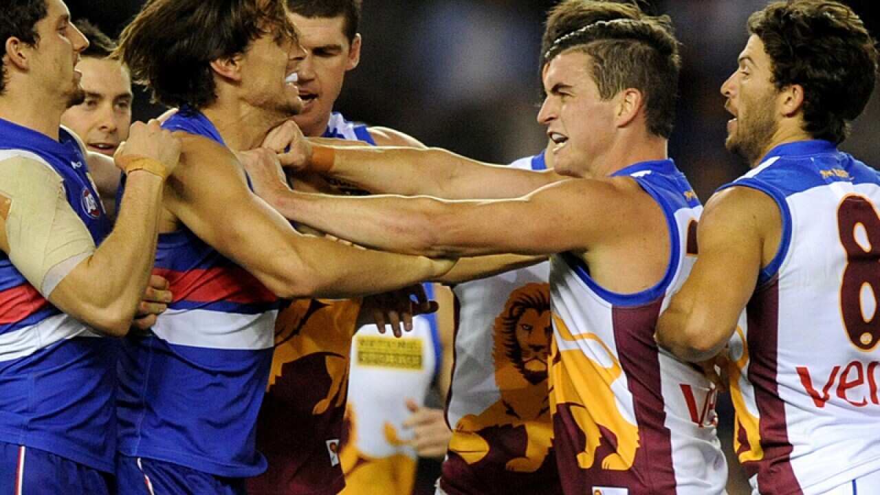 Brisbane and Western Bulldog players wrestle