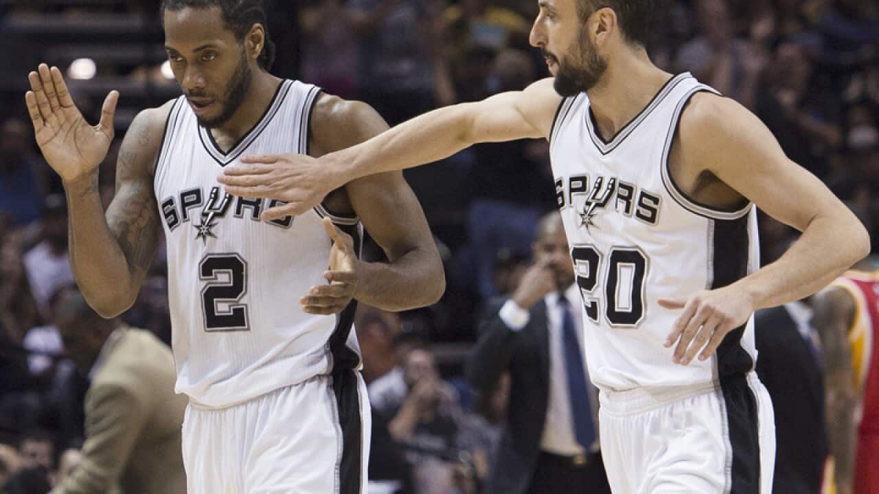 San Antonio players Manu Ginobili (R) and Kawhi Leonard