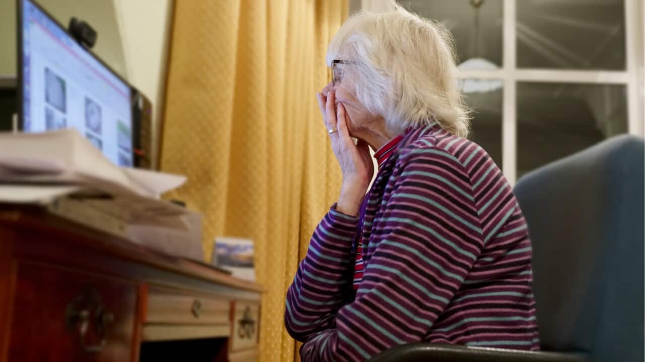 An older person receiving an unexpected message on her screen