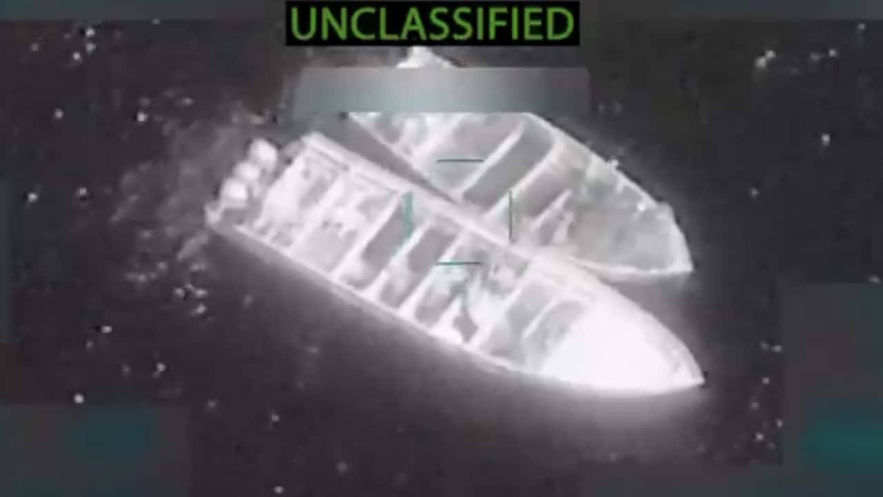 A screen grab of an aerial image of two boats huddled together in water, with the word unclassified written on top.