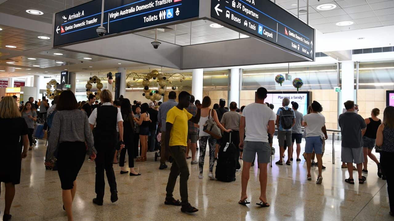Travellers are seen at Overseas Arrivals and Departures at Sydney's International Airport