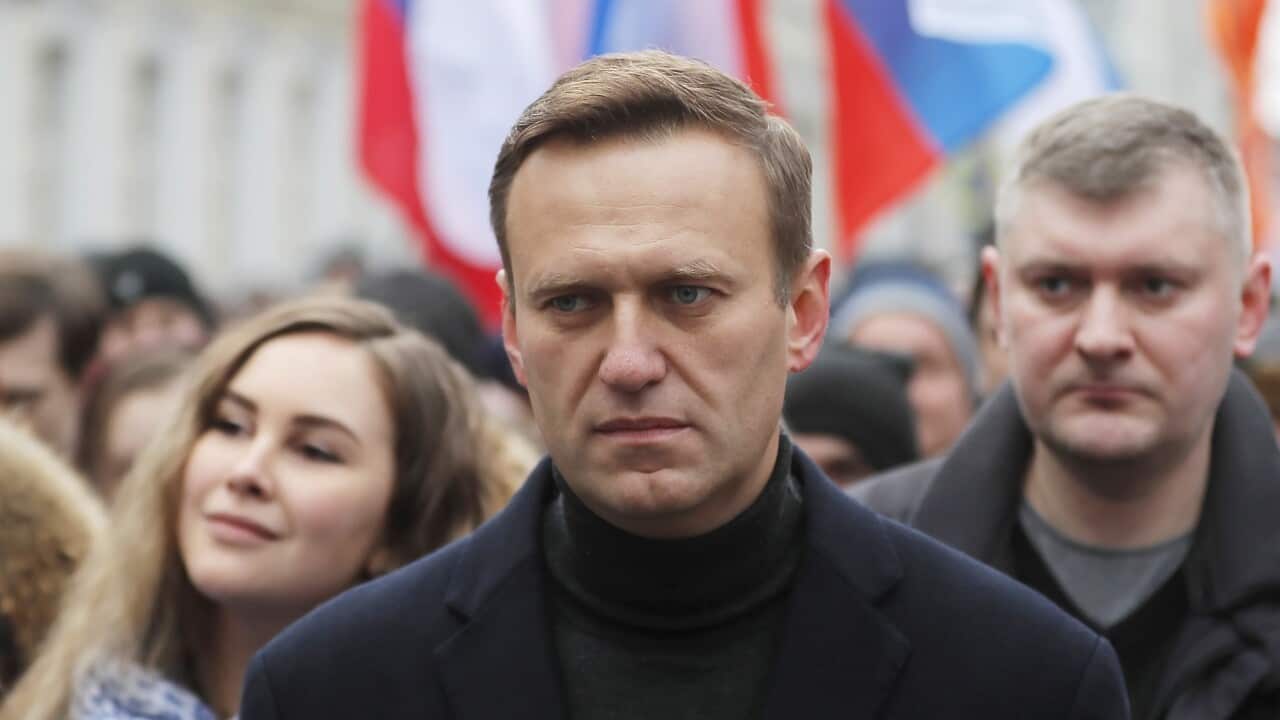 Alexei Navalny marching with a group of people
