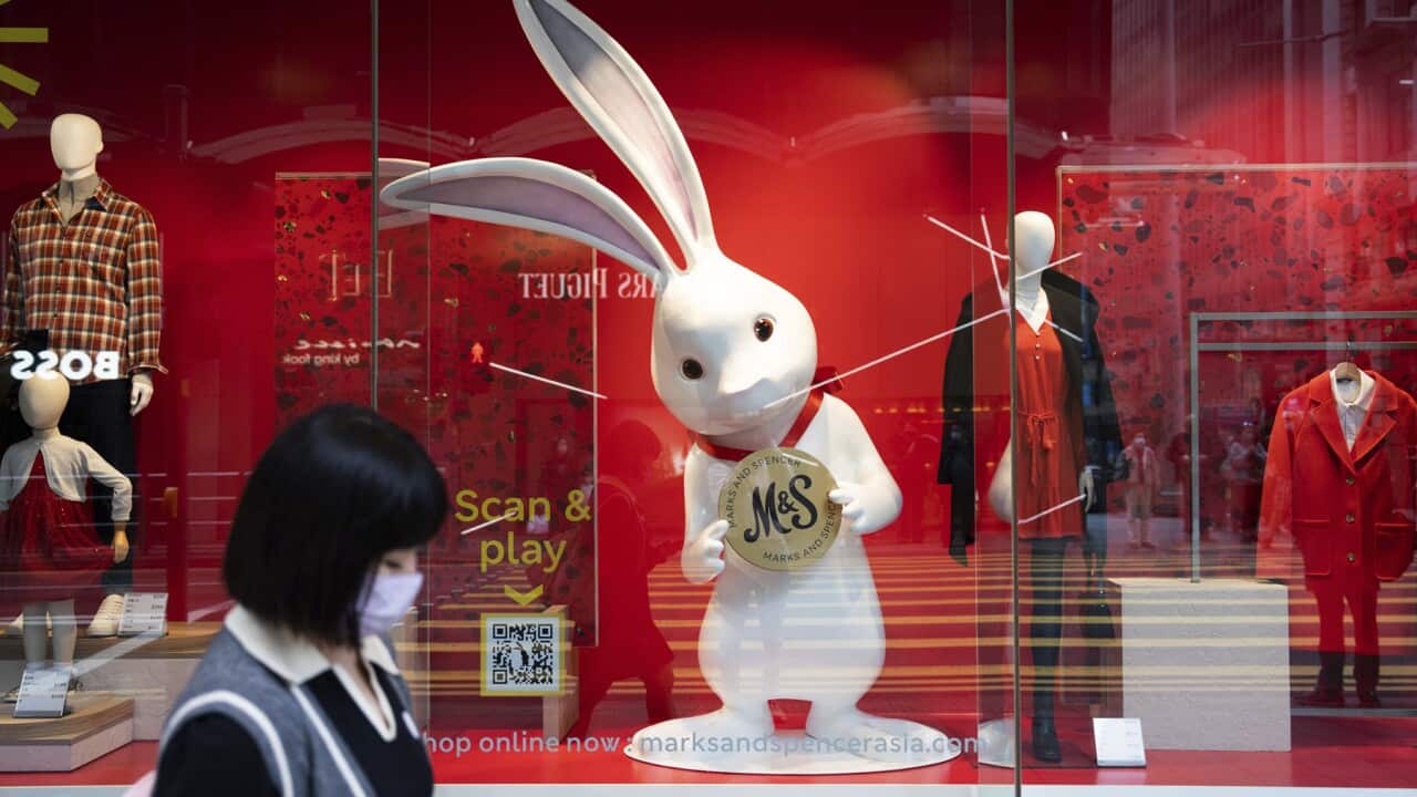 A woman passes a rabbit in central Hong Kong