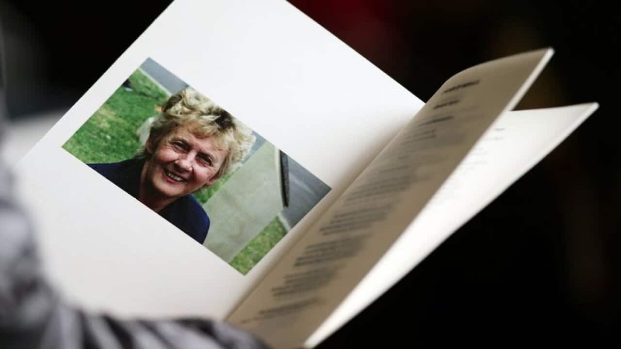 A mourner reads the order of service during a State Memorial service for Betty Cuthbert at Sydney Cricket Ground on August 21, 2017 in Sydney