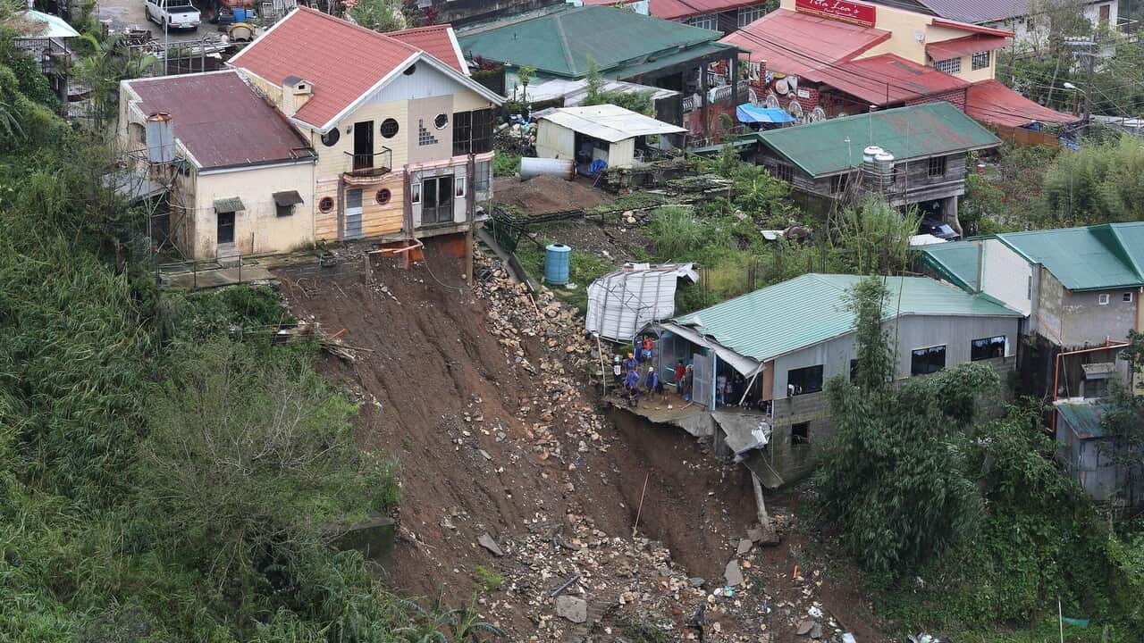 Rescuers conduct search and retrieval operation to locate three missing persons who were buried due to a landslide in Balacbac, Baguio City, North of Manila.