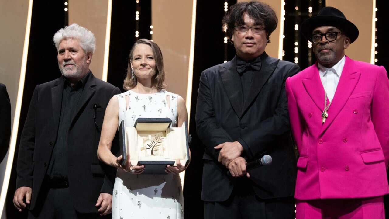 Jodie Foster poses on stage with Spanish director Pedro Almodovar , South Korean director Bong Joon-Ho and ury president and Director Spike Lee after she received a Palme d'Or Life Achievement Award during the opening ceremony of the Cannes Film Festival