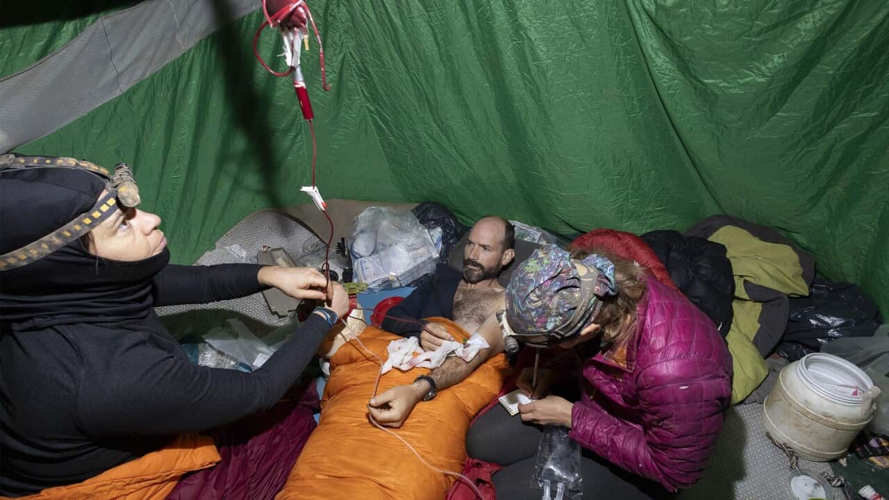 Man accepting first aid from rescue crews.