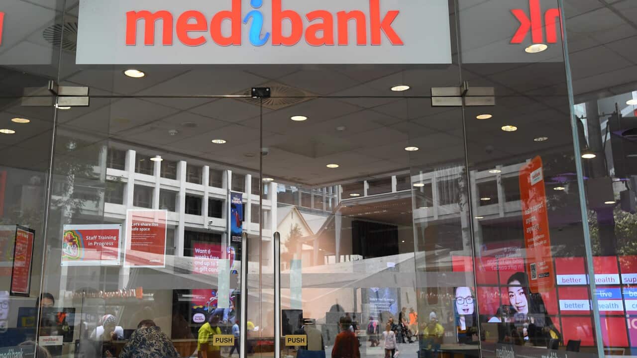 A Medibank sign in Brisbane this year with customers at glass doors