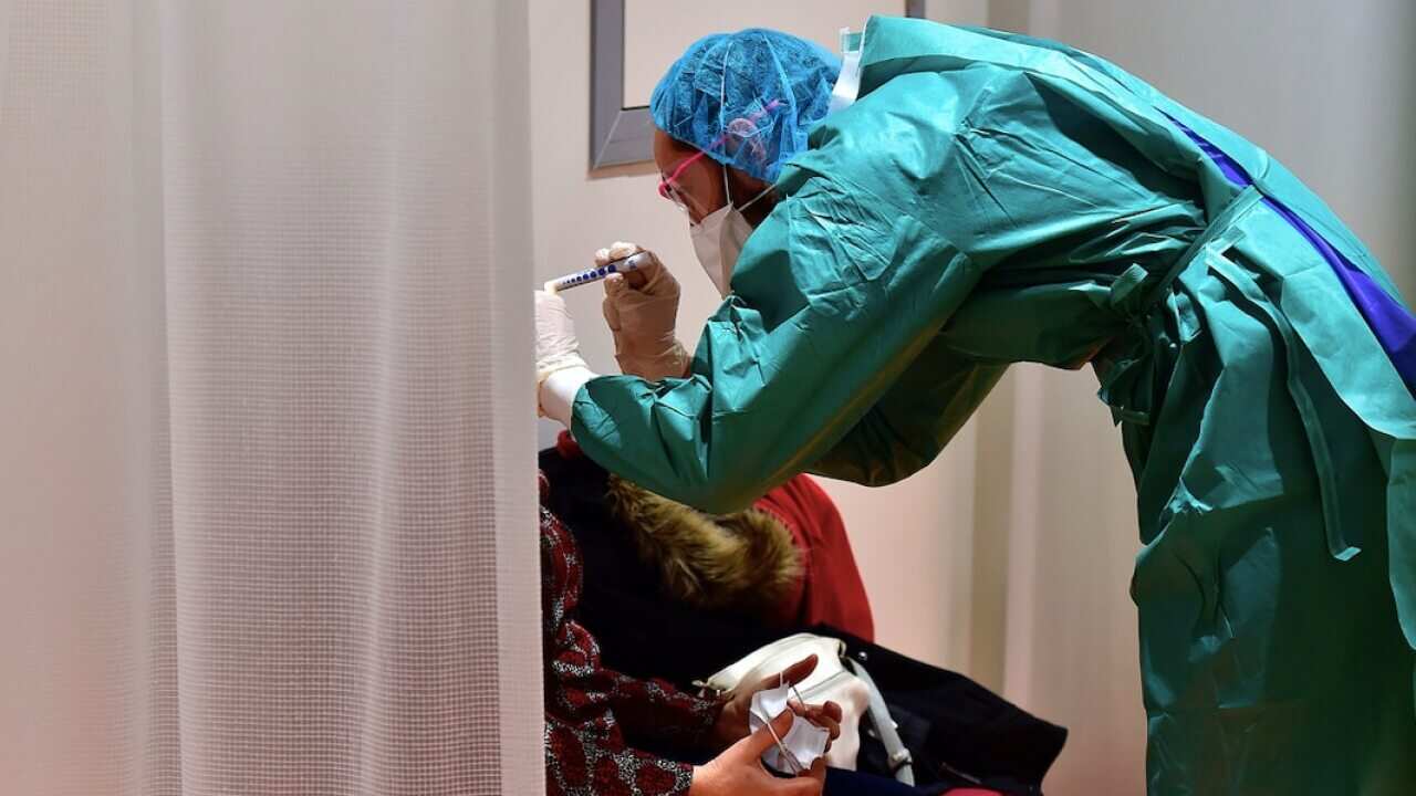 A doctor examines a patient during the COVID-19 ourbreak.