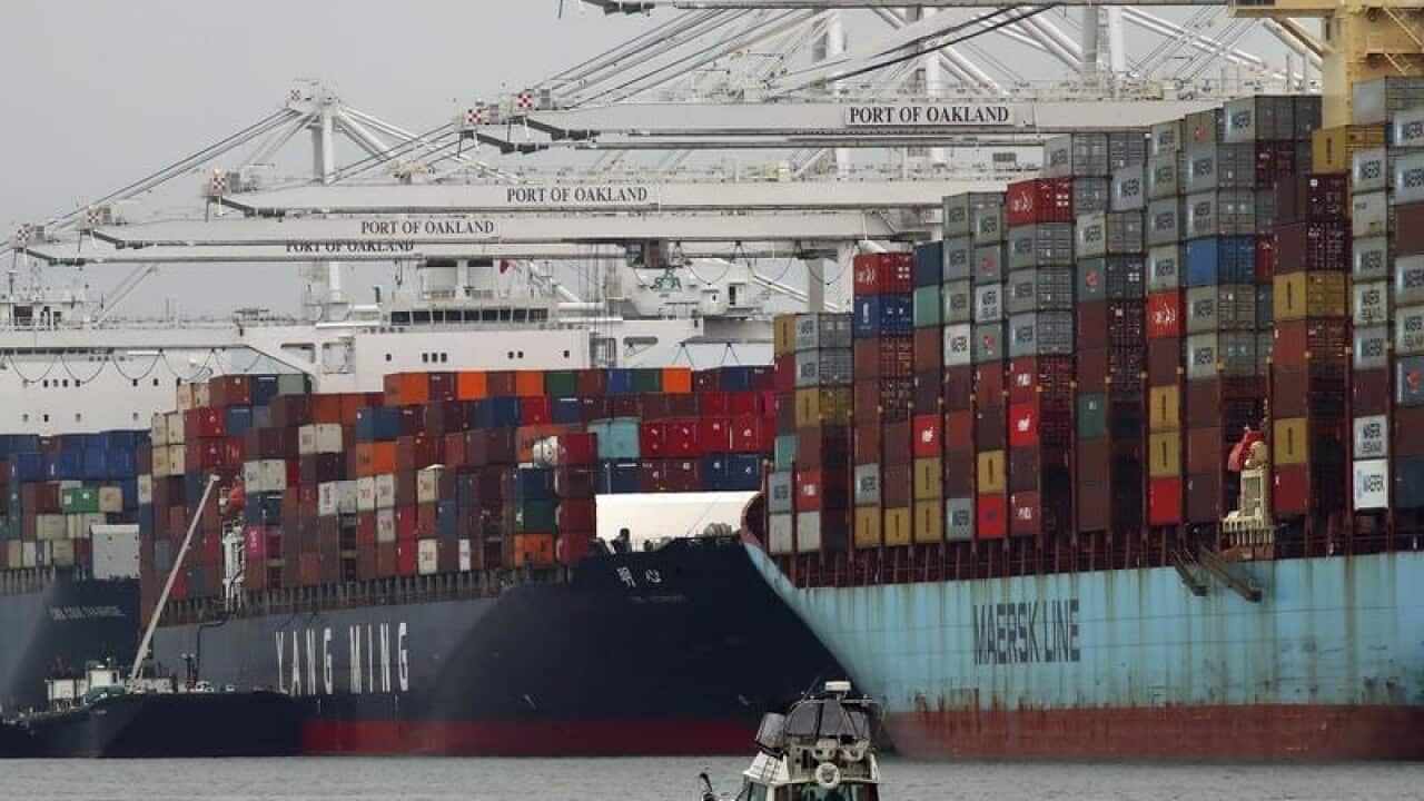 Container ships unload at a California port