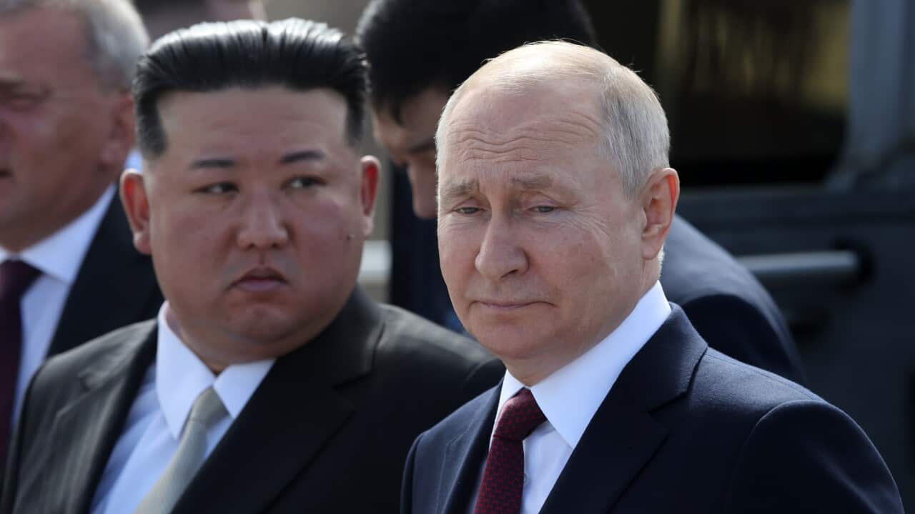 Kim Jong-un (left) and Vladimir Putin (right) wearing suits and ties and standing outside