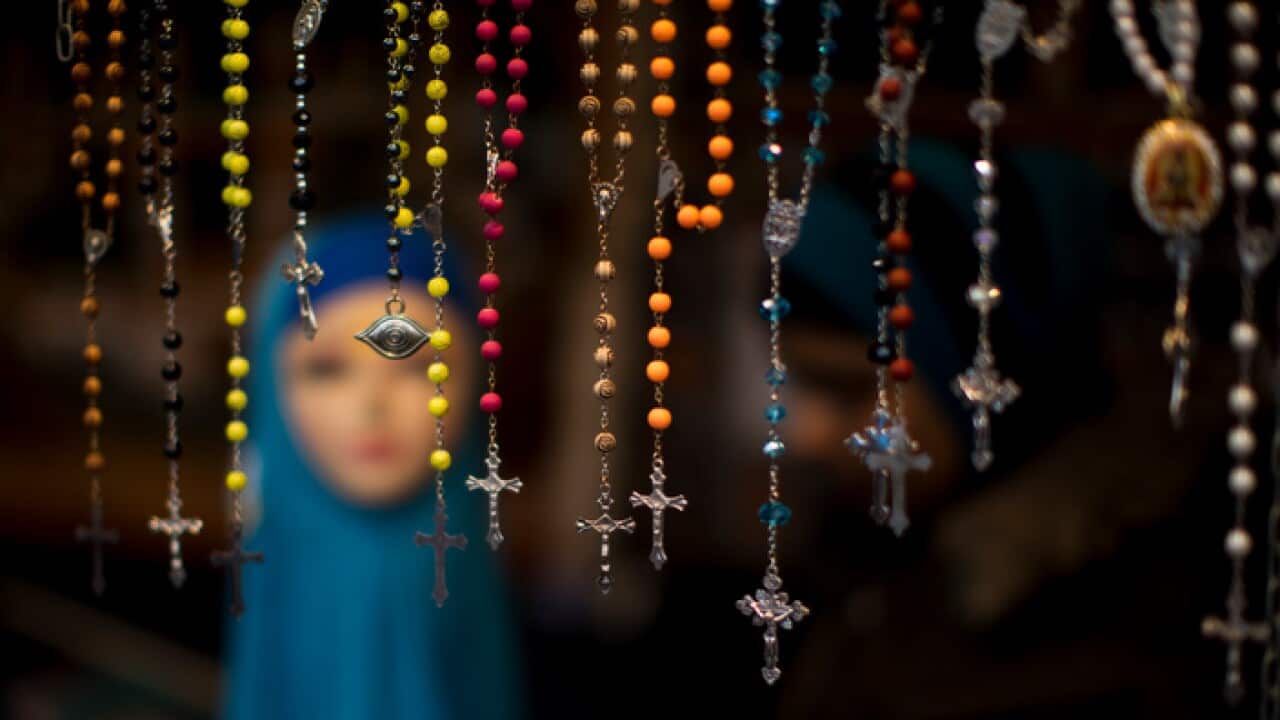 Image: Rosary beads selling in front of a mannequin with a headscarf in the Netherlands (AAP