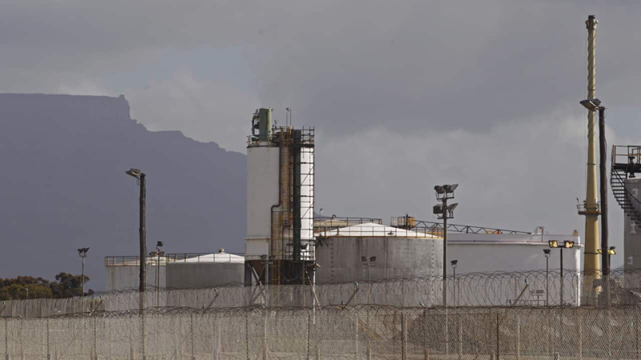 A fuel refinery in foreground near the city of Cape Town, South Africa