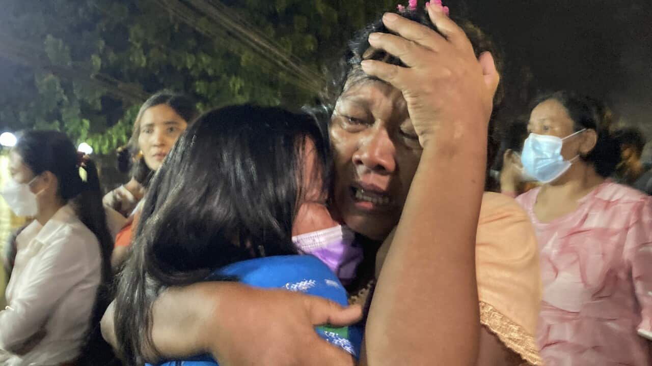 A mother reacts after her daughter, left, was released from Insein Prison in Yangon, Myanmar, Monday, Oct. 18, 2021