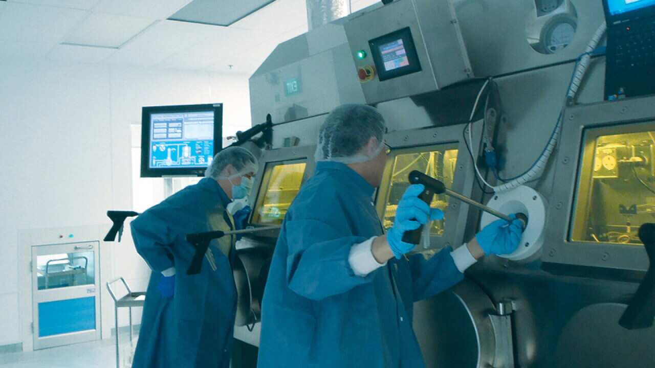 Workers in a Sirtex lab.