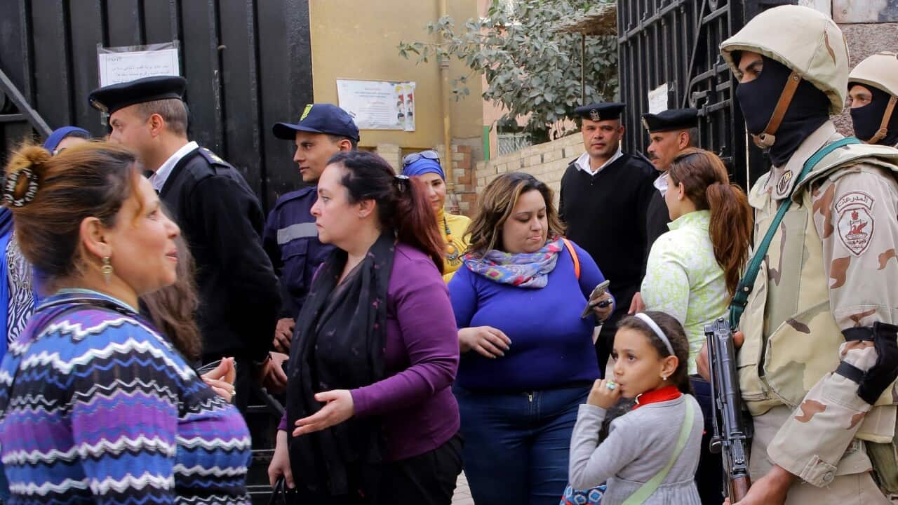 Egyptian soldiers stand guard as voters arrive at a polling station during day two of the Egyptian presidential election in Cairo, Egypt.