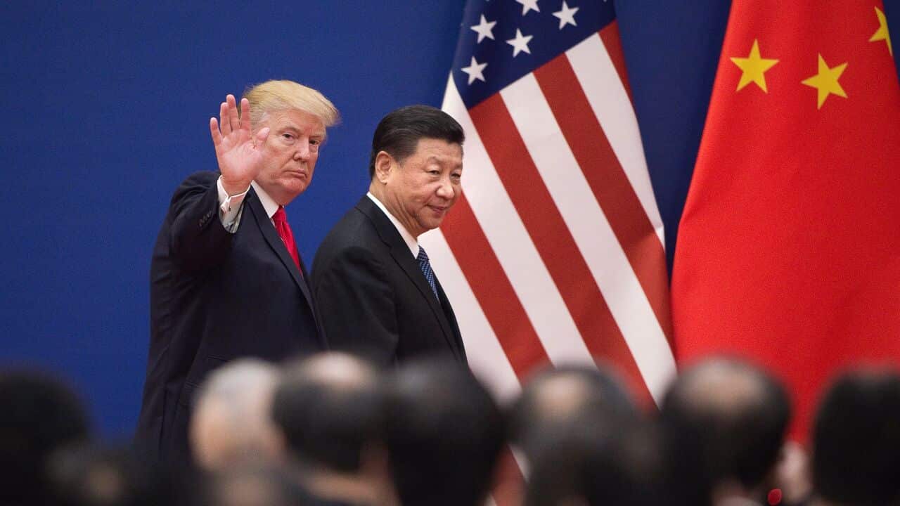 US President Donald Trump (L) and China's President Xi Jinping leave a business leaders event at the Great Hall of the People in Beijing.
