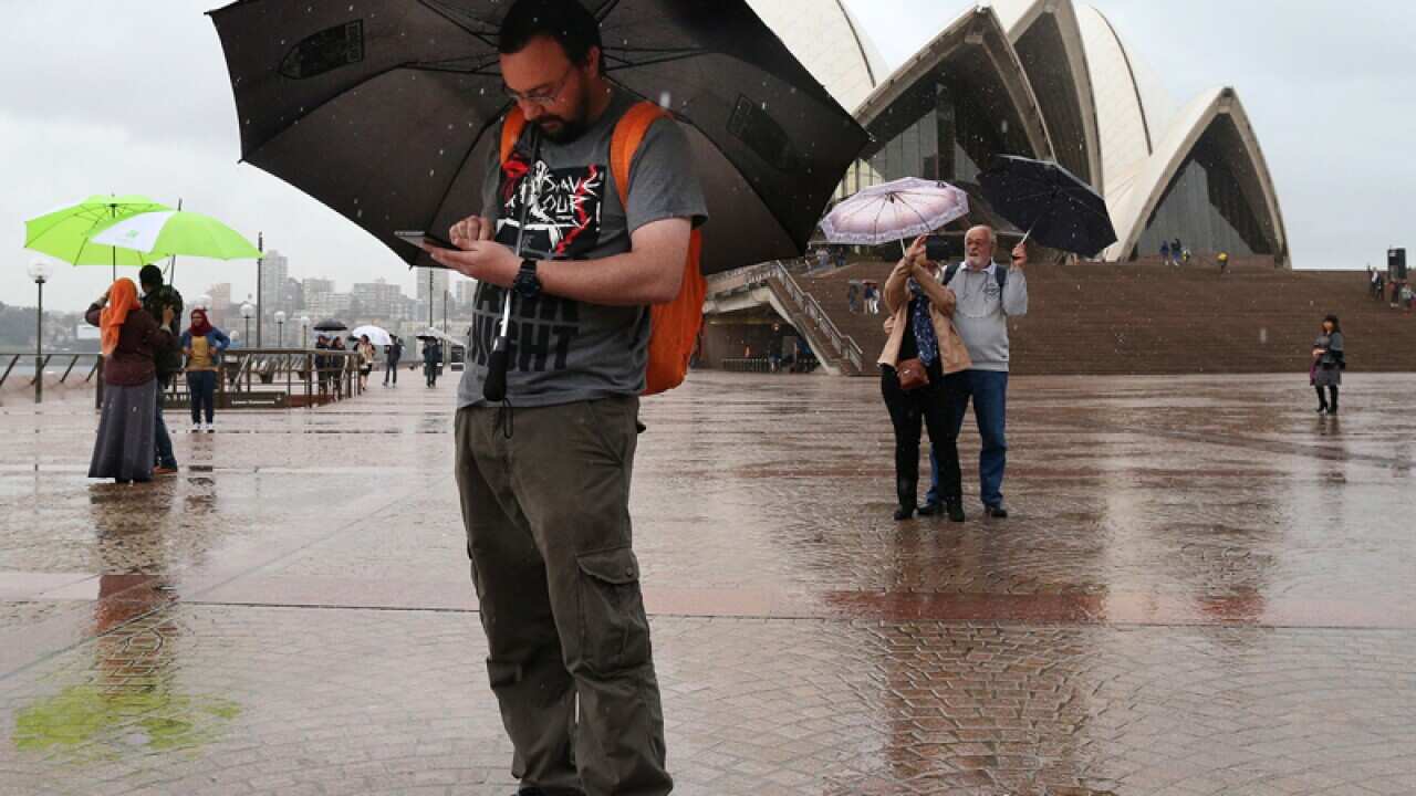 A man plays Pokemon Go near the Sydney Opera House